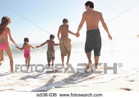 Family walking into the sea View Large Photo Image Stock Photograph - Family walking into the sea. Fotosearch