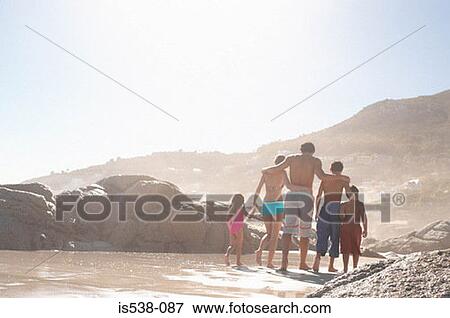 Family walking on a beach View Large Photo Image Stock Photo - Family walking on a beach. Fotosearch