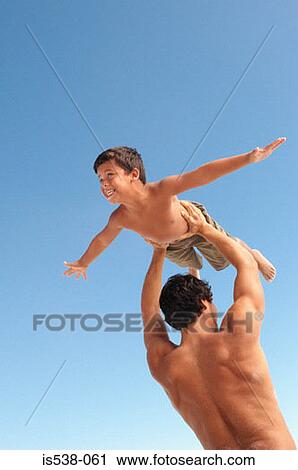 Father giving an aeroplane to his son View Large Photo Image Stock Image - Father giving an aeroplane to his son. Fotosearch