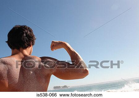 Man flexing his muscles View Large Photo Image Stock Photograph - Man flexing his muscles. Fotosearch
