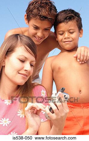 Mother and sons with mobile phone View Large Photo Image Stock Image - Mother and sons with mobile phone. Fotosearch