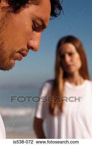 Profile of a man with a woman in the background View Large Photo Image Stock Image - Profile of a man with a woman in the background. Fotosearch