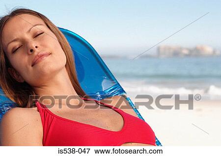 Woman sunbathing View Large Photo Image Stock Photo - Woman sunbathing. Fotosearch