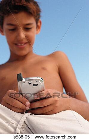 Young boy with mobile phone View Large Photo Image Stock Image - Young boy with mobile phone. Fotosearch