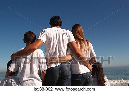 Stock Image - Young family on a beach. Fotosearch
