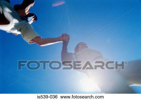 Stock Photograph - Blurred people holding hands. Fotosearch