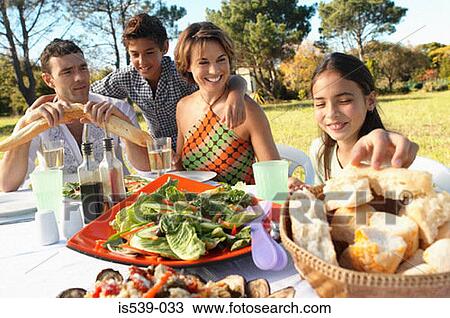 Family eating meal in garden View Large Photo Image Stock Image - Family eating meal in garden. Fotosearch
