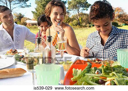 Family eating meal in garden View Large Photo Image Stock Photo - Family eating meal in garden. Fotosearch