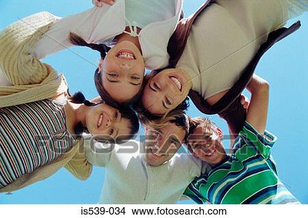 Picture - Family hugging in circle. Fotosearch