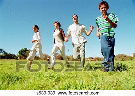 Family running in field View Large Photo Image Stock Photo - Family running in field. Fotosearch