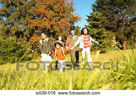 Family running in meadow View Large Photo Image Stock Photograph - Family running in meadow. Fotosearch