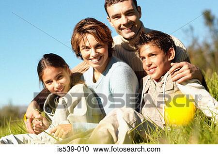 Family sitting in meadow View Large Photo Image Stock Image - Family sitting in meadow. Fotosearch