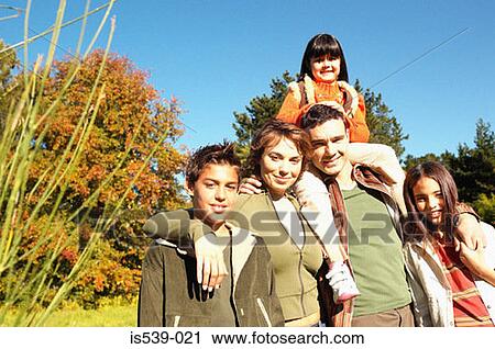 Family standing in meadow View Large Photo Image Stock Image - Family standing in meadow. Fotosearch
