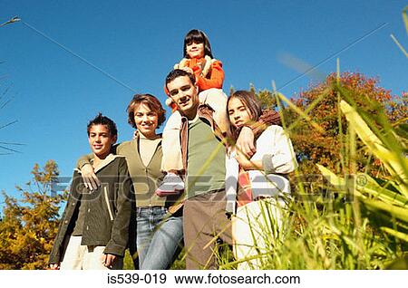 Family standing in meadow View Large Photo Image Stock Photo - Family standing in meadow. Fotosearch