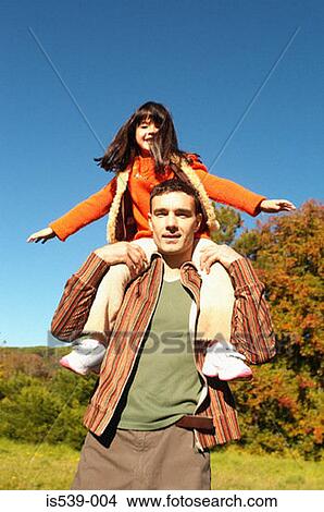 Picture - Father shoulder carrying daughter. Fotosearch