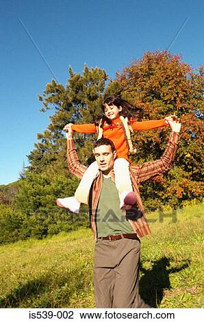 Father shoulder carrying daughter View Large Photo Image Stock Image - Father shoulder carrying daughter. Fotosearch