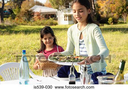 Girls preparing meal in garden View Large Photo Image Stock Image - Girls preparing meal in garden. Fotosearch