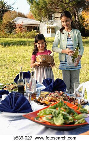 Girls preparing meal in garden View Large Photo Image Stock Photo - Girls preparing meal in garden. Fotosearch