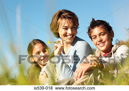 Mother and children in meadow View Large Photo Image Stock Photo - Mother and children in meadow. Fotosearch