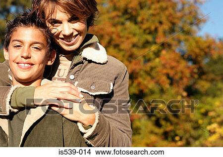 Mother and son hugging View Large Photo Image Picture - Mother and son hugging. Fotosearch