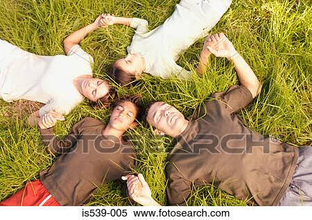 People lying in circle on grass View Large Photo Image Stock Photography - People lying in circle on grass. Fotosearch