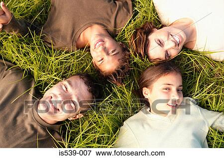 People lying on grass View Large Photo Image Stock Photo - People lying on grass. Fotosearch