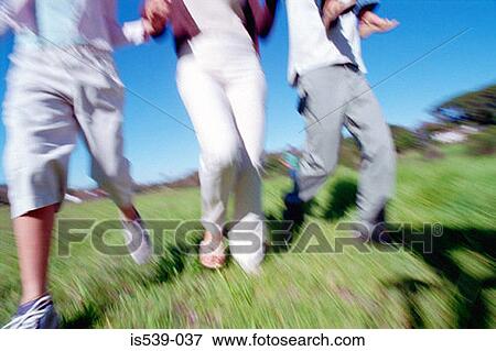 People running in field View Large Photo Image Stock Photo - People running in field. Fotosearch