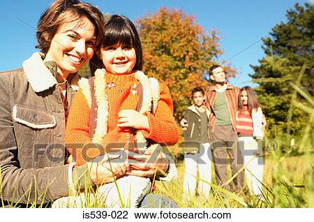 Smiling family in meadow View Large Photo Image Stock Image - Smiling family in meadow. Fotosearch