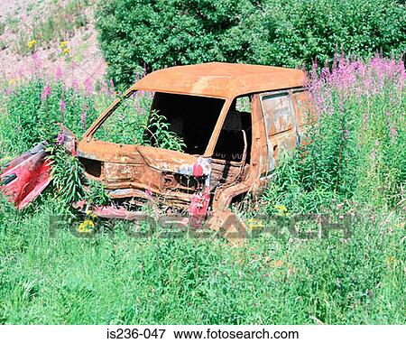 Stock Photo - Abandoned car in a field. Fotosearch