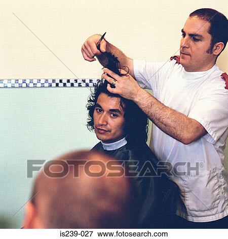 Stock Photo - Barber cutting hair. Fotosearch