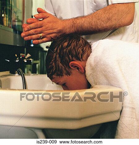 Barber washing boys hair View Large Photo Image Stock Photo - Barber washing boys hair . Fotosearch