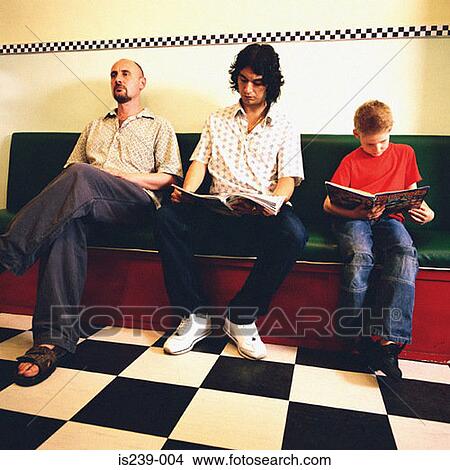Picture - Customers waiting in barbershop. Fotosearch