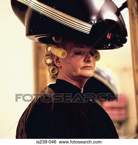 Stock Photograph - Woman with hair in rollers. Fotosearch