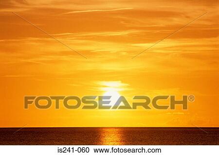 Stock Image - Sunset over ocean. Fotosearch