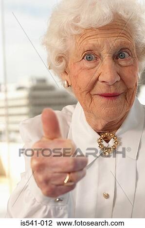 Stock Image - Elderly woman giving the thumbs up. Fotosearch