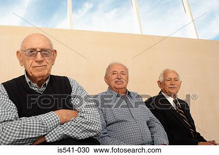 Stock Image - Portrait of three elderly men seated. Fotosearch