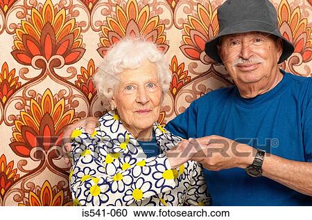 Smiling elderly couple holding hands View Large Photo Image Stock Image - Smiling elderly couple holding hands. Fotosearch