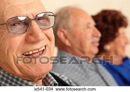 Picture - Smiling elderly man in foreground. Fotosearch