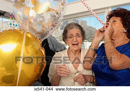 Picture - Two elderly women celebrating. Fotosearch