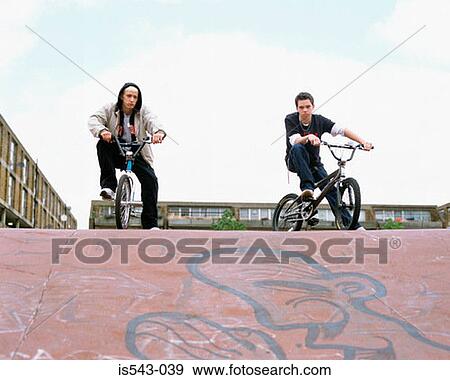 Boys riding BMX bicycles View Large Photo Image Stock Photo - Boys riding BMX bicycles. Fotosearch