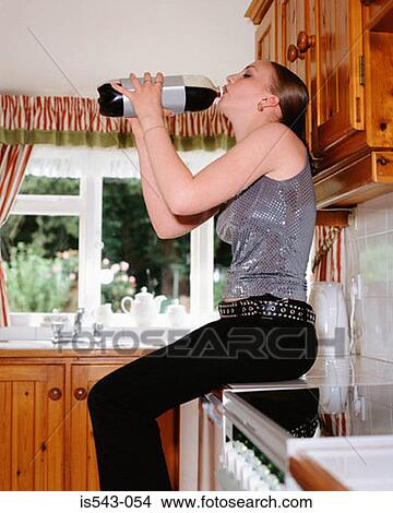 Girl drinking cola in kitchen View Large Photo Image Picture - Girl drinking cola in kitchen. Fotosearch