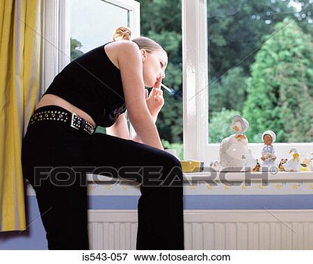 Girl smoking by window View Large Photo Image Stock Photo - Girl smoking by window. Fotosearch