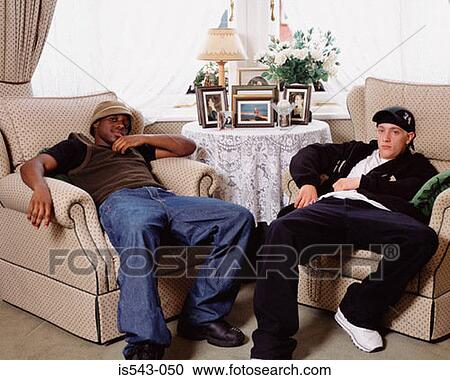 Stock Image - Teenage boys in living room. Fotosearch