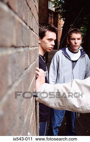 Teenage boys leaning on wall View Large Photo Image Stock Image - Teenage boys leaning on wall. Fotosearch