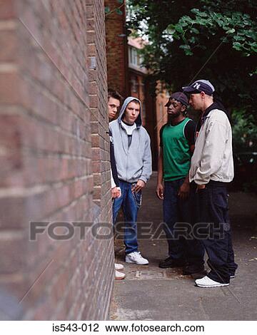 Teenage boys standing by wall View Large Photo Image Stock Image - Teenage boys standing by wall. Fotosearch