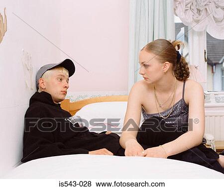 Stock Photo - Teenage couple on bed. Fotosearch