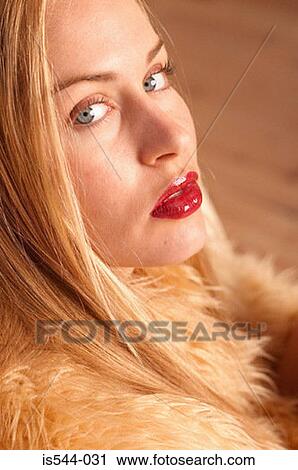 Stock Image - Portrait of blonde looking to camera. Fotosearch
