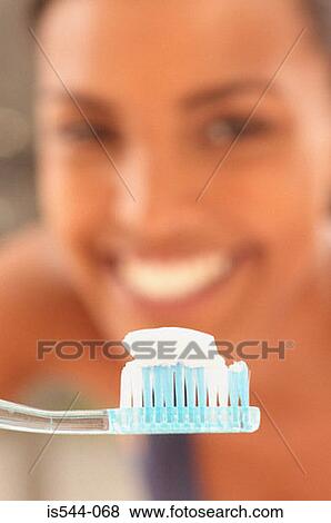 Smiling young woman with toothbrush View Large Photo Image Stock Photo - Smiling young woman with toothbrush. Fotosearch