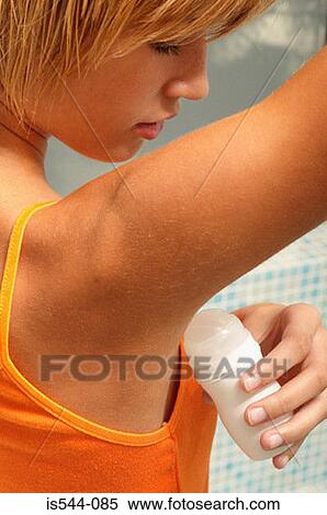 Young woman applying deodorant View Large Photo Image Stock Photography - Young woman applying deodorant. Fotosearch