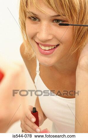 Young woman applying mascara View Large Photo Image Stock Photo - Young woman applying mascara. Fotosearch